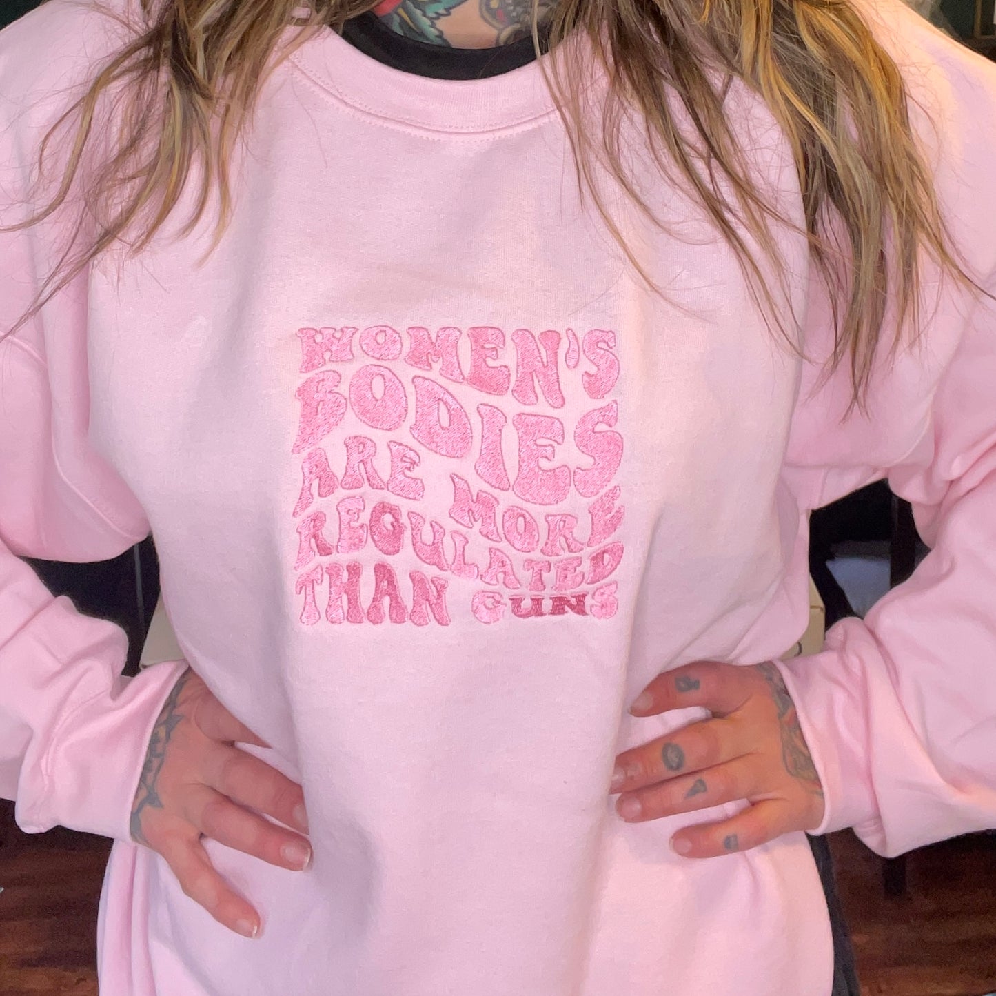 Women's Bodies Are More Regulated Than Guns Embroidered Unisex Crewneck Sweatshirt
